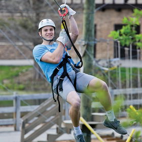 boy riding zip line